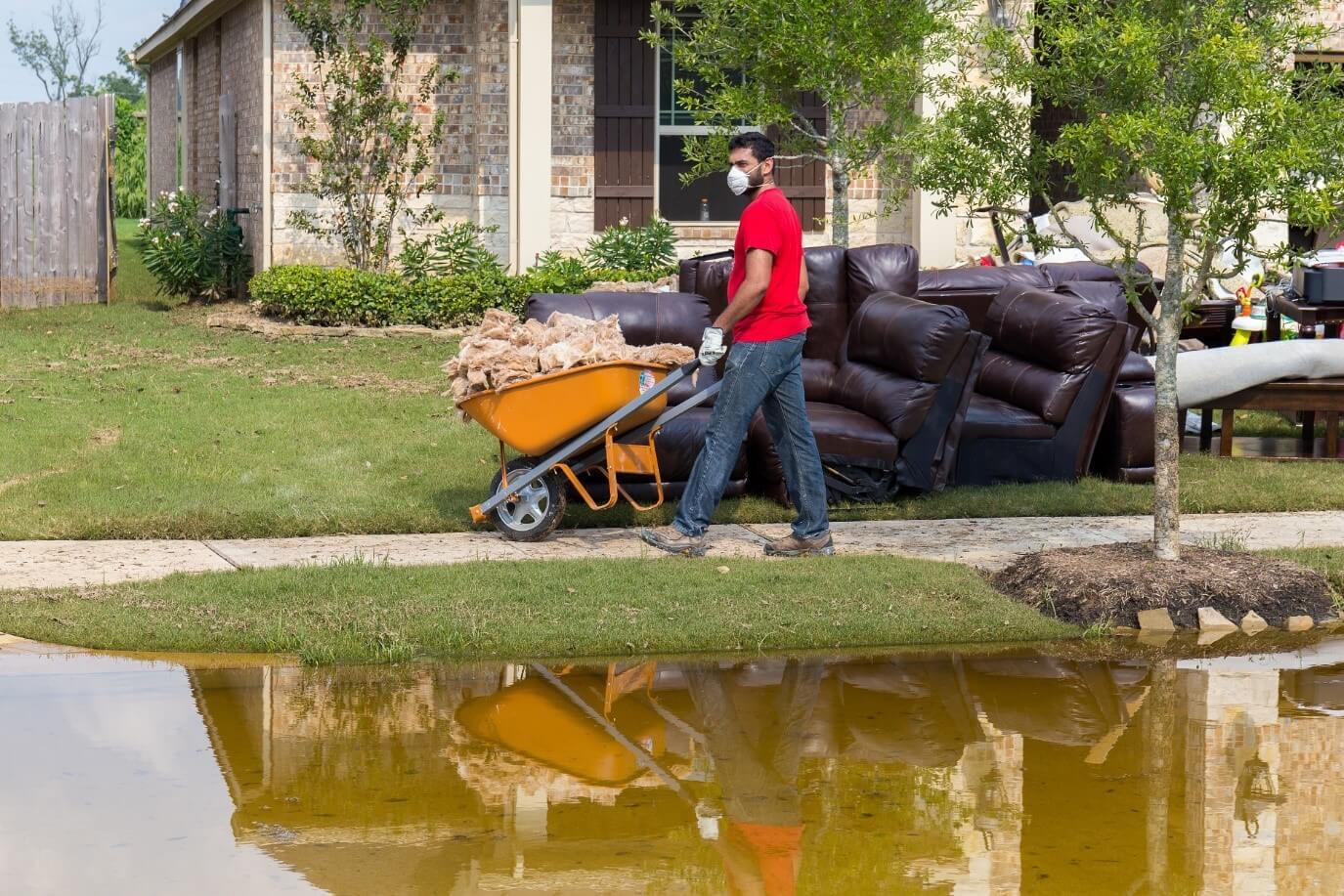 A man cleaning up after a hurricane